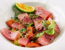 Smoked salmon salad in white bowl close up photo