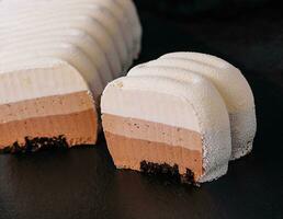 three chocolate mousse cakes with milk photo