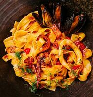 pasta with mussels, squid and octopus closeup photo