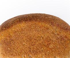 Black bread in the form of a brick on white background photo