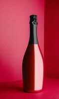 red Champagne bottle on light red background photo