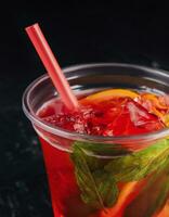 Alcoholic red fruit cocktail with a mint in leaf photo