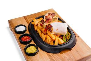 beef veggie wrap with french fries and vegetables photo