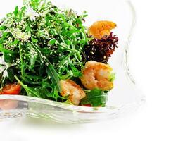 Portion of gourmet shrimp salad with arugula photo