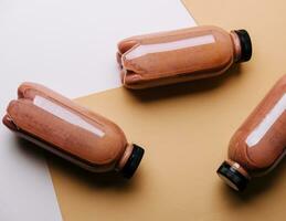 chocolate smoothies milkshake in bottles on brown background photo