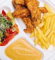 Chicken nuggets with french fries and mustard sauce photo