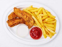 Chicken nuggets with french fries top view photo