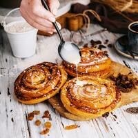 Homemade raisin roll pastry with vanilla icing photo