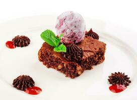 Tasty chocolate brownie with blueberry ice cream photo