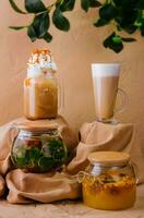 Caramel iced latte with whipped cream and various teas photo