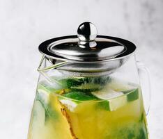 Passionfruit iced green tea or lemonade with lime and mint photo