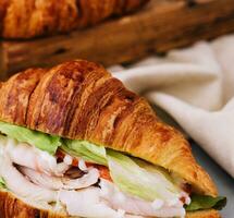 croissant sandwich with ham, tomato and lettuce photo