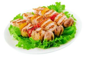 pork skewers with grilled bell peppers and mushrooms photo