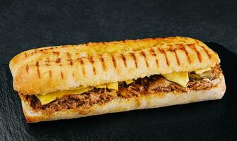 long sandwich with chicken, cucumbers and cheese photo