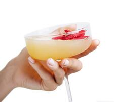 woman's hand holding daiquiri cocktail with strawberry photo