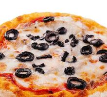 mini pizza with olives and cheese on plate photo