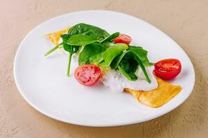 Omelet with tomatoes and herbs on a plate photo