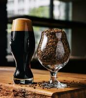 tasty dark beer and glass of wheat on wooden photo