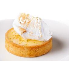 Lemon tartlet with meringue on plate photo