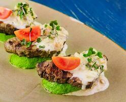 veal on zucchini with mushroom sauce photo