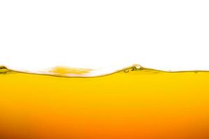 orange juice is isolated on white background. healthy fresh drink and natural waves. close up view. photo