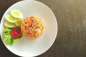 Tom Yum Fried Rice. Great tasting Thai food. On an old cement table. Top view. photo