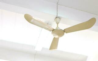 Old style electric ceiling fan inside the building. photo