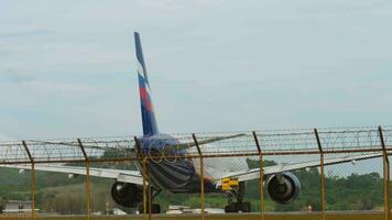 PHUKET, THAILAND JANUARY 26, 2023 Aeroflot passenger plane on the runway at Phuket airport, rear view. Airliner ready for takeoff video