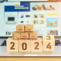 2024 New Year Online Shopping concept. Shipping Boxes on laptop computer. Sale and discount during Christmas and New Year holiday, ecommerce, shipping delivery, logistics and Cyber Monday photo