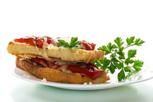 hot sandwich of fried toast bread with baked peppers and cheese photo