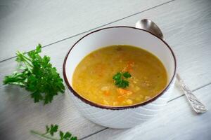 dried pea soup in a plate with herbs photo