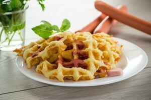 cooked fried potato waffles with sausage stuffing inside photo