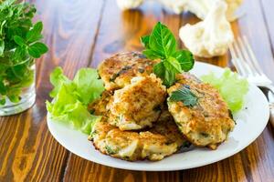 cooked vegetarian fried cauliflower cutlets, in a plate . photo