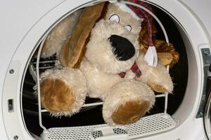 children's soft toy in the dryer basket after washing photo