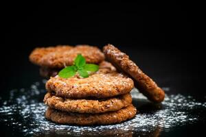 cocido dulce harina de avena galletas en negro antecedentes foto