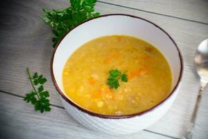 dried pea soup in a plate with herbs photo