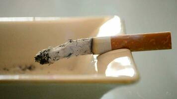 Tobacco cigarette burning in ashtray video