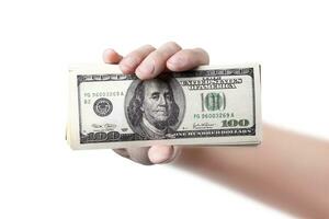 A hand shows a money isolated on white or png transparent background 100 dollars close up photo