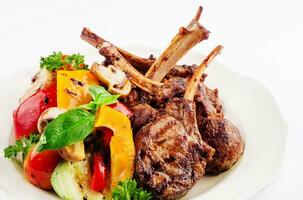 Grilled lamb rack with baked vegetables photo