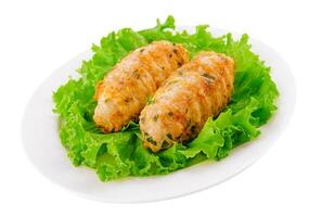 Chicken cutlets with salad greens on plate photo