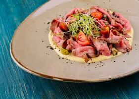 fried cured and sliced veal tongue with mashed potatoes photo