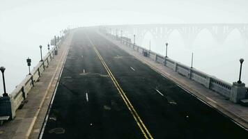 An empty illuminated asphalt road in a thick fog video