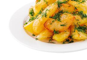 Fried potato slices with dill on plate photo