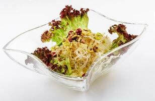 coleslaw with pistachios in a glass bowl photo