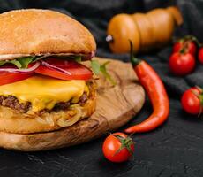 Tasty grilled home made burger with beef, tomato, cheese, onion and lettuce photo
