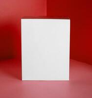 White gift box on red background photo