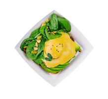 avocado sandwich and poached eggs on rye bread photo