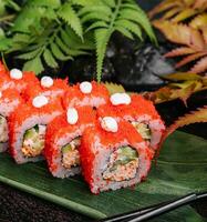 California Sushi roll cutting on a bamboo leaf photo