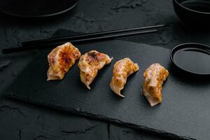 Gyoza or dumplings snack with soy sauce photo