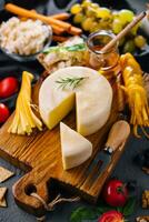 Cheese plate with variety of cheese top view photo